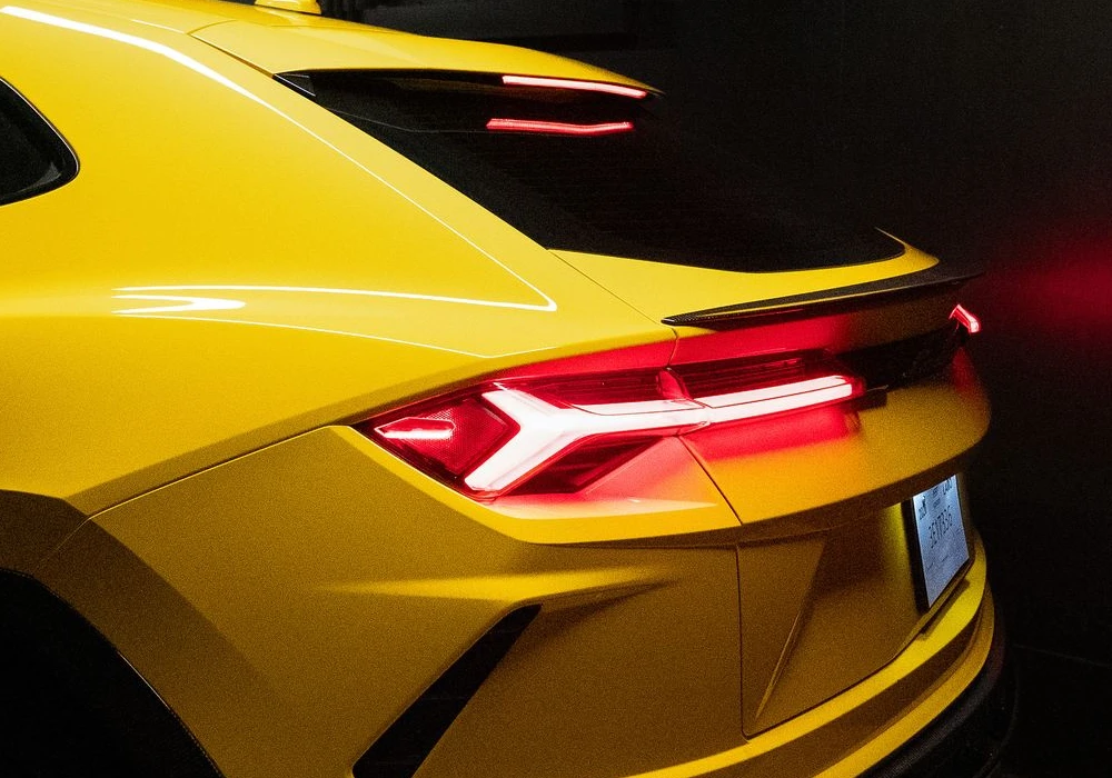 Yellow luxury sports car rear view with distinctive taillights, showcasing sleek design and modern styling, relevant to Apex Exotic Rentals' high-end vehicle offerings in Arizona.