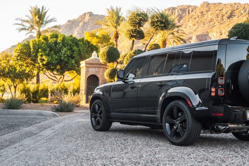 Black Land Rover Defender 110 V8 rental in Scottsdale, rear three-quarter view