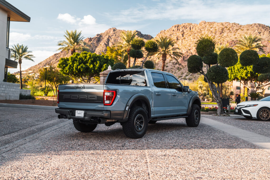 Gray Ford F-150 Raptor rental in Scottsdale, rear three-quarter view