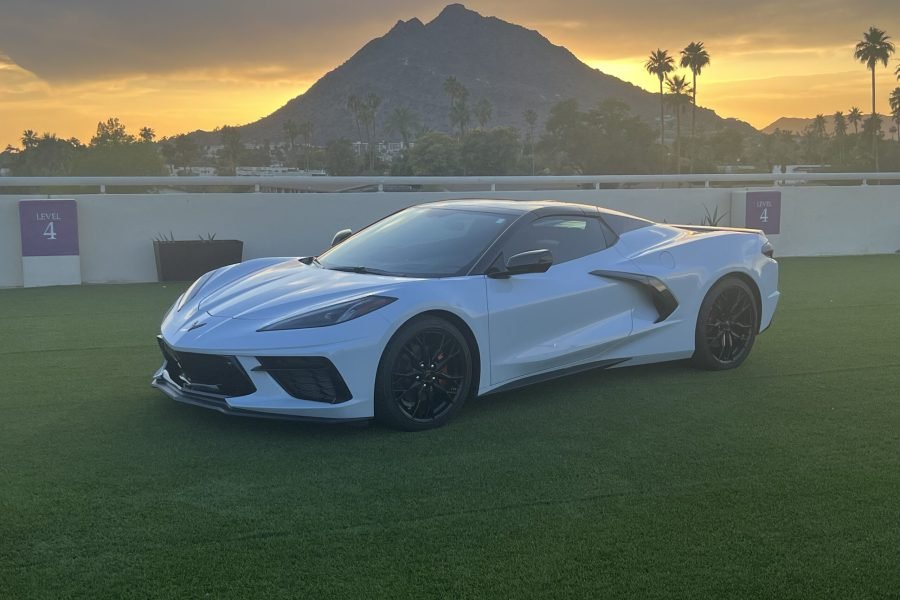 C8 Corvette sports car in Scottsdale, Arizona, against a sunset backdrop, showcasing its sleek design and aggressive stance, ideal for luxury car rentals.